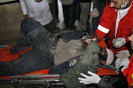 A Palestinian who was injured in an Israeli army strike is rushed to Shifa hospital in Gaza City, on Tuesday, January 13, 2009. [Xinhua]