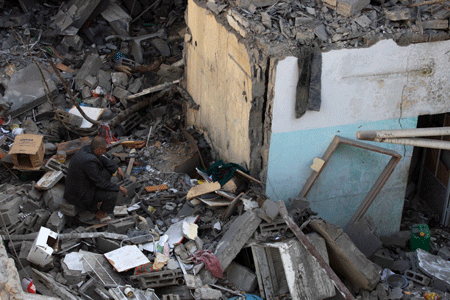 Palestinians inspect the rubble of a destroyed building following the Israeli military operations in Gaza City on January 14, 2009. [Xinhua]