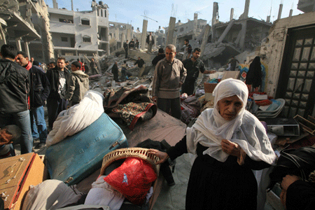 Palestinians search for their belongings in the rubble of a destroyed building following the Israeli military operations in Gaza City on January 14, 2009. [Xinhua]