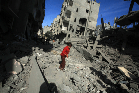 PPalestinians inspect the rubble of a destroyed building following the Israeli military operations in Gaza City on January 14, 2009. [Xinhua]