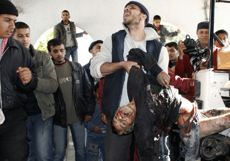 A Palestinian who was injured in an Israeli army strike is rushed to Shifa hospital in Gaza City, on Tuesday, January 13, 2009.