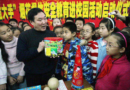 A teacher instructs pupils in safety rules with fireworks and crackers at No.22 Primary School in Urumqi, capital of northwest China's Xinjiang Uygur Autonomous Region, on January 13, 2009. As the winter vacation draws near, a safety education campaign held by local education authority started at the school on Tuesday.