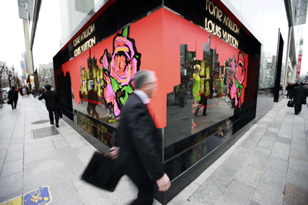 A Japanese walks past a shopwindow of a department store in the Ginza shopping district in Tokyo, capital of Japan, on January 20, 2009. Department store sales in Japan shrank by 4.3 percent year-on-year in 2008 to 7.38 trillion yen (US$81 billion), said the Japan Department Stores Association on Monday.