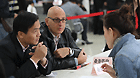 People consult about enterprise registration application at the service lobby of the Shanghai free trade zone (FTZ), in Shanghai, east China, Oct. 25, 2013.