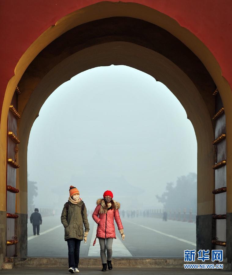 “天灰灰，雾茫茫，帝都深“霾”功与名。”1月12日，两位戴口罩的游客在天坛公园游览。当日，北京被大雾笼罩。 新华社记者 李文摄 