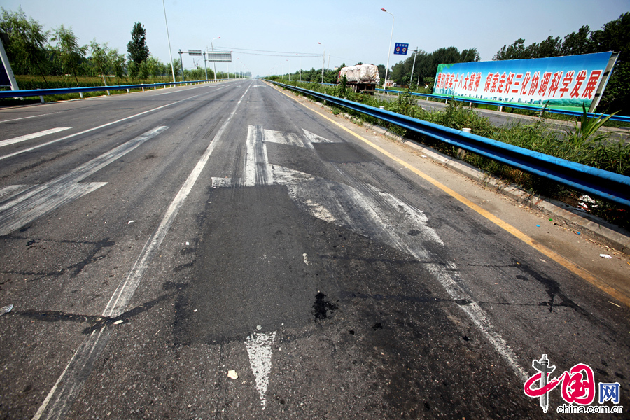 2013年8月11日，河南省滑县县城至大广高速公路快速通道，该快速通道建成不到一年时间，已有多处路面损毁、修补。 中国网图片库 王子瑞摄影