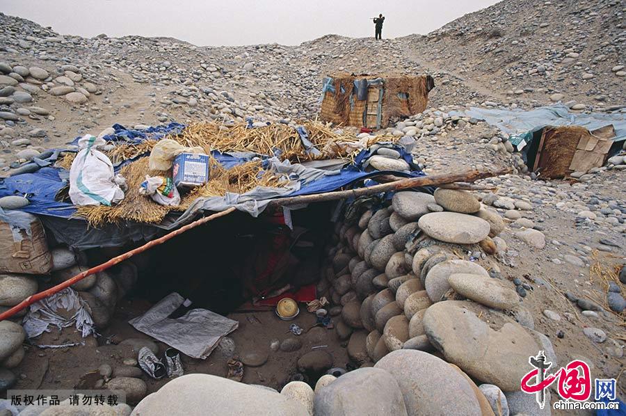 半地下的石屋是采玉人自建的栖息处，经济条件好点的能收拾的干净点，或者在地上搭个茅草帐篷。
