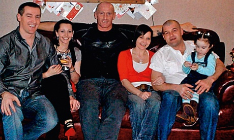 Gareth Thomas on the sofa with his family.