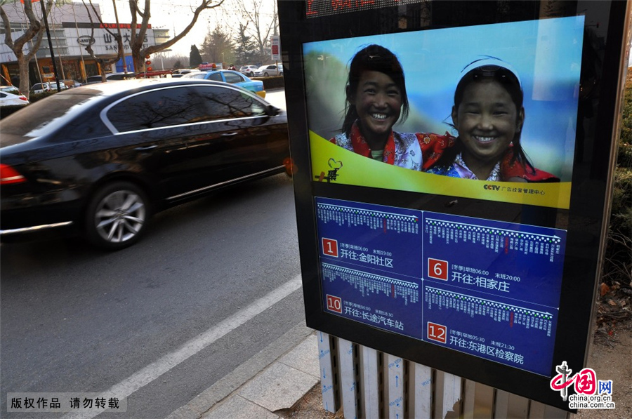  2015年2月9日，在山东省日照市海曲路一公交车站，市民在查看智能公交电子站牌。近日，山东省日照市首批5个智能公交电子站牌在海曲路上亮相。这种新型智能电子公交站牌，具有车辆定位显示、天气预报、公益信息发布等功能，同时还可以通过无线4G网络，进行远程维护。市民在乘坐公交车时，公交车到哪里了一看便知，极大的方便了市民出行。中国网图片库 刘明照/摄