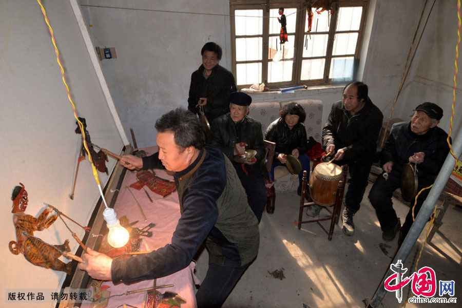 2月1日，申国瑞在创办的皮影戏班紧张地排练皮影戏来迎接下一场演出，也在有意识的培养下一个接班人。中国网图片库 郝群英摄 