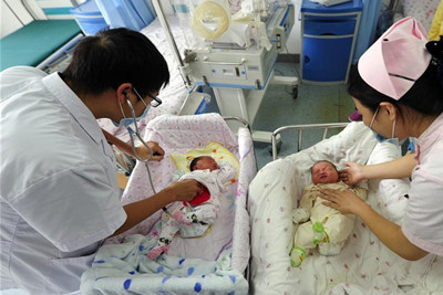 7月12日，宣城市妇女儿童医院的医护人员为两名“洪水宝宝”进行身体检查。