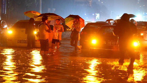 7月19日，市民推着自行车走过河南安阳市一段积水路段。新华社记者李安摄 　　 7月19日，汽车和行人在河南安阳市一段积水道路上。新华社记者李安摄 　　7月19日，车辆从河南安阳市一段积水路段驶过。