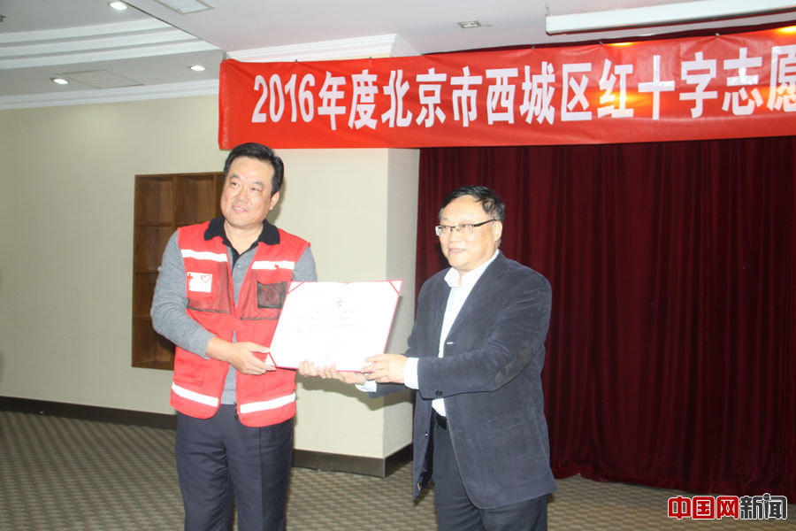 西城区红十字会党组书记、常务副会长王志东为“希望之光”志愿者服务队颁发“社会好人”荣誉证书。中国网 记者张艳玲 摄
