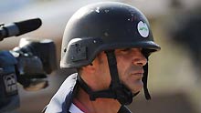 A journalist with helmet and bullet-proof vest looks into north Gaza Strip at the top of a hill near Gaza border, south Israel, on January 4, 2009. Hundreds of journalist and reporters from all over the world swarm into Israel and the west bank since Israel began the air strike to Gaza Strip on December 27, 2008.