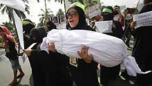 People hold a demonstration in front of the Israeli Embassy to the Philippines to protest against Israel's continued military attacks on the Palestinians in the Gaza Strip, in Manila on January 5, 2009.