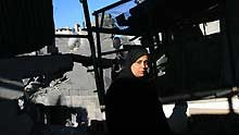 A Palestinian woman inspects rubbles after an Israeli airstrike in Rafah, southern Gaza Strip, on January 6, 2009. Israeli Prime Minister Ehud Olmert on Tuesday rejected a European Union (EU) request for a 48-hour ceasefire in the Gaza Strip, vowing to push ahead the offensive in the Gaza Strip till security is restored to southern regions of Israel.