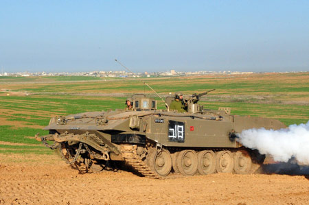 An Israeli tank runs in the northern Gaza Strip on January 7, 2009. The Israeli army has said that it would hold fire in the Gaza Strip for three hours every day from January 7 to allow local residents to prepare basic supplies.