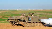 An Israeli tank runs in the northern Gaza Strip on January 7, 2009. The Israeli army has said that it would hold fire in the Gaza Strip for three hours every day from January 7 to allow local residents to prepare basic supplies.