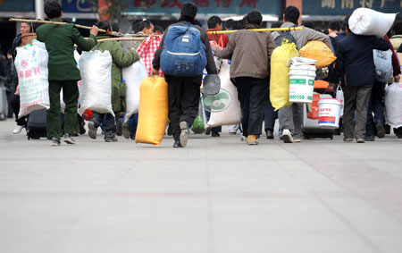 Migrant workers enter the Changsha Railway Station in Changcha, capital of central-south China's Hunan Province, on January 8, 2009. The Spring Festival travel period, known as Chunyun in Chinese, began to see its passenger peak in Changsha as the college students and migrant workers started to return home.