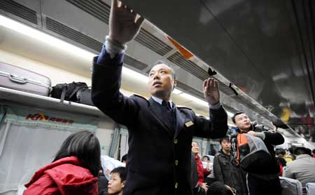 A steward works on a train at the Changsha Railway Station in Changsha, capital of central-south China's Hunan Province, on January 8, 2009. The Spring Festival travel period, known as Chunyun in Chinese, will start officially on January 11. Some 30 temporary trains are ready in Changsha as the preparation work is in place to ensure the safe and orderly operation during the peak travel season.