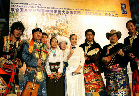 Chinese singer Zhu Zheqin poses with performers of ethnic minorities when she was named as the United Nations Development Programme China National Goodwill Ambassador in Beijing, capital of China, on January 9, 2009. Zhu Zheqin, also known as Dadawa, was named the ambassador to enhance the protection of China's ethnic minority cultures.