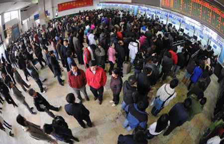 People queue up to buy tickets at the Changsha Railway Station in Changsha, capital of central-south China's Hunan Province, on January 8, 2009. The Spring Festival travel period, known as Chunyun in Chinese, began to see its passenger peak in Changsha as the college students and migrant workers started to return home.