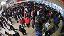 People queue up to buy tickets at the Changsha Railway Station in Changsha, capital of central-south China's Hunan Province, on January 8, 2009. The Spring Festival travel period, known as Chunyun in Chinese, began to see its passenger peak in Changsha as the college students and migrant workers started to return home.