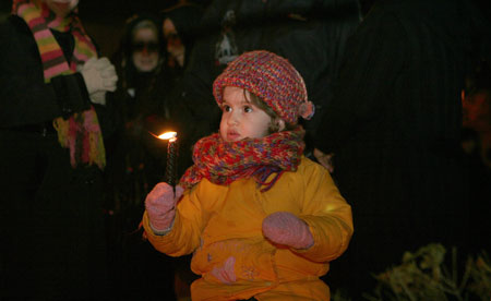 An Irani child holds a candle while praying for the children in Gaza during a rally at the Palestine Square in Tehran, capital of Iran, on January 7, 2009. Thousands of Irani people gathered at the square Wednesday night to support the Palestinian people.