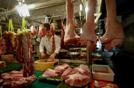 A meat vendor chops pork in a market in Manila, capital of the Philippines, on January 8, 2009. A team of international experts is investigating the Ebola Reston virus found in pigs at two farms in the northern Philippines, the World Health Organization (WHO) said on Thursday.