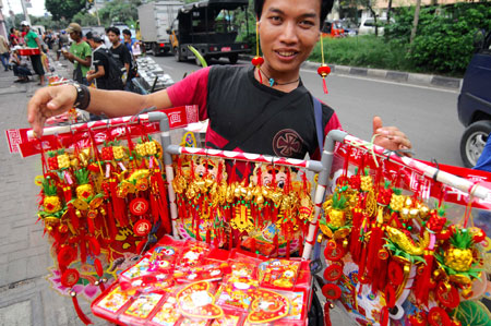 A peddler displays decorations at the Chinatown in Jakarta, captial of Indonesia, on January 8, 2009. As the traditional Chinese Spring Festival is coming, red lanterns, mascots and various decorations come into market in Jakarta.