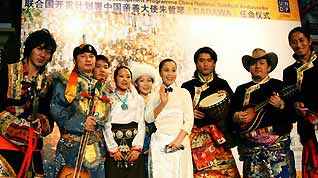 Chinese singer Zhu Zheqin poses with performers of ethnic minorities when she was named as the United Nations Development Programme China National Goodwill Ambassador in Beijing, capital of China, on January 9, 2009. Zhu Zheqin, also known as Dadawa, was named the ambassador to enhance the protection of China's ethnic minority cultures.