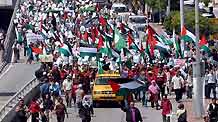 Demonstrators march to the United States Embassy to Malaysia to hold a protest against the US support for Israel's continued military attacks on the Palestinians in the Gaza Strip, in Kuala Lumpur, January. 9, 2009.