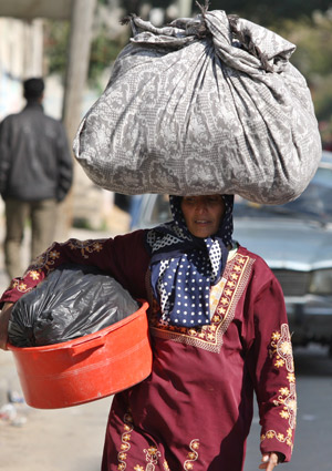 A Palestinian woman flees after Israel's offensive in Gaza, Jan. 9, 2009.