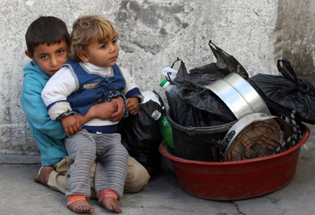 Palestinians leave their homes after Israel's offensive in Gaza, Jan. 9, 2009.