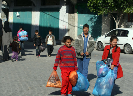 Palestinians leave their homes after Israel's offensive in Gaza, Jan. 9, 2009.