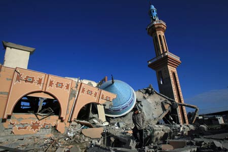 A Palestinian walks past the ruins of the al-Fadilah mosque, which was destroyed in an Israeli air strike in Rafah in the southern Gaza Strip on January 11, 2009. Israeli troops continued their air and ground offensive to the Gaza strip on Sunday. According to Gaza emergency department, the death toll since the beginning of the offensive has mounted to 900. [Xinhua]