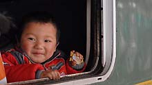 A child looks out of the train window at the Guiyang Railway Station in Guiyang, capital of southwest China's Guizhou Province, on January 11, 2009. The 40-day Spring Festival transportation, or Chunyun in Chinese, began on Sunday, with the estimation of 2.32 billion people to travel over the Chinese lunar New Year starting from January 26 this year.