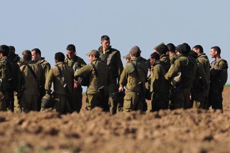 Israeli soldiers stand together during training on January 10, 2009. The Israel Defense Forces (IDF) on Sunday has begun sending its reservists into the Gaza Strip, signaling an expansion of the IDF ground incursion in the Hamas-ruled coastal enclave. 