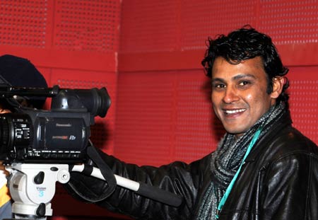 A reporter of India's New Delhi Television stands at the venue of the second meeting of the 9th Tibetan Regional Committee of the Chinese People's Political Consultative Conference in Lhasa, capital of southwest China's Tibet Autonomous Region, on January 12, 2009.