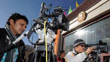 Foreign reporters work outside the venue of the second meeting of the 9th Tibetan Regional Committee of the Chinese People's Political Consultative Conference in Lhasa, capital of southwest China's Tibet Autonomous Region, on January 12, 2009.