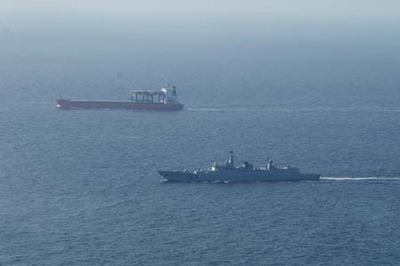 Chinese missile destroyer Wuhan (R) escorts a cargo ship in the waters of the Gulf of Aden on Jan. 12, 2009. The Chinese fleet started to carry out the second escort mission against pirates in the Gulf of Aden on Monday. 