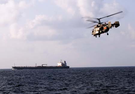 A Chinese navy helicopter keeps alert over a cargo ship in the waters of the Gulf of Aden on January 12, 2009. 