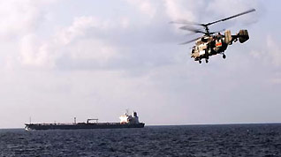 A Chinese navy helicopter keeps alert over a cargo ship in the waters of the Gulf of Aden on January 12, 2009.