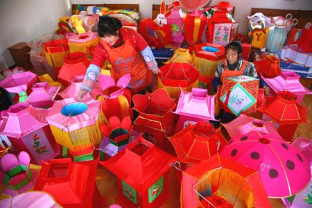 Workers make lanterns at a workshop at Hongmiao Village in Huairou District of Beijing, capital of China, on January 12, 2009. Some 2,200 lanterns have been made at the workshop for the Spring festival since the beginning of the last month of the lunar year.