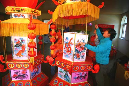 Workers make lanterns at a workshop at Hongmiao Village in Huairou District of Beijing, capital of China, on January 12, 2009. Some 2,200 lanterns have been made at the workshop for the Spring festival since the beginning of the last month of the lunar year. 