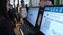 An employee tries a digital system designed for the blind in Hangzhou, capital of east China's Zhejiang Province, on January 12, 2009. A program to improve information accessibility for China's disabled population was launched here by China Disabled Persons' Federation and the Ministry of Science and Technology on Monday.