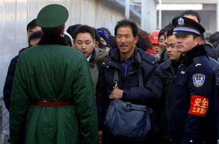 People stand in line for tickets at the Beijing West Railway Station in Beijing, capital of China, on January 13, 2009, as the traditional Chinese Lunar New Year approaches.