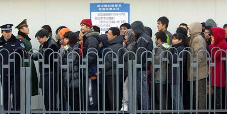 People stand in line for tickets at the Beijing West Railway Station in Beijing, capital of China, on January 13, 2009, as the traditional Chinese Lunar New Year approaches.