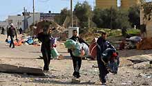 Palestinians retrieve their belongings for their house in the al Karama area of Gaza City on January 13, 2009. Israeli soldiers fought heavy battles with local militants in Gaza early on Tuesday. Medics said on Monday that over 900 people have been killed and more than 4,100 others wounded since Israeli military operation on December 27, 2008.