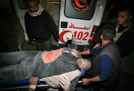 Palestinian medics send a wounded man of the Civil Defense, who was hurt in an Israeli strike, to Shifa hospital in Gaza City, on January 14, 2009. Gaza emergency chief Mo'aweya Hassanein said on Wednesday night that the Israeli army killed on Wednesday 28 Palestinians and wounded 80 others. [Xinhua]